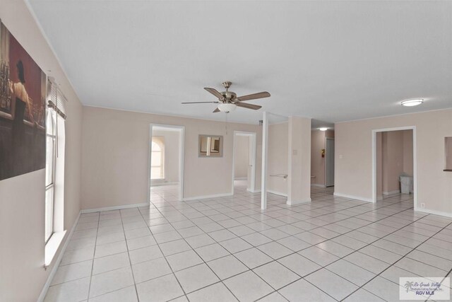 tiled empty room featuring ceiling fan