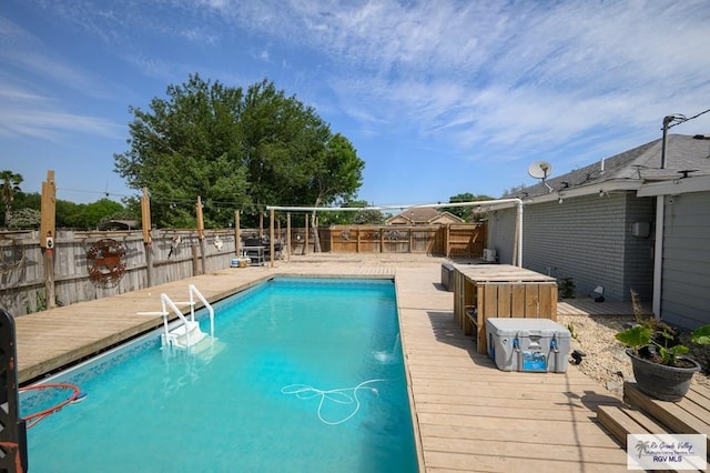 view of pool with a wooden deck