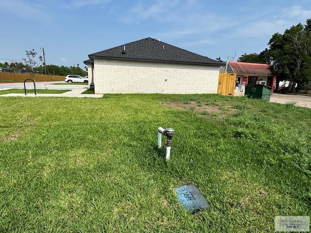 view of side of home with a lawn