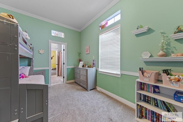 carpeted bedroom featuring crown molding and baseboards