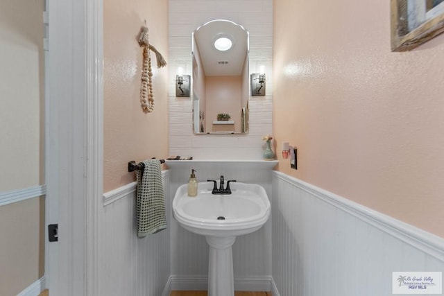 bathroom featuring a wainscoted wall