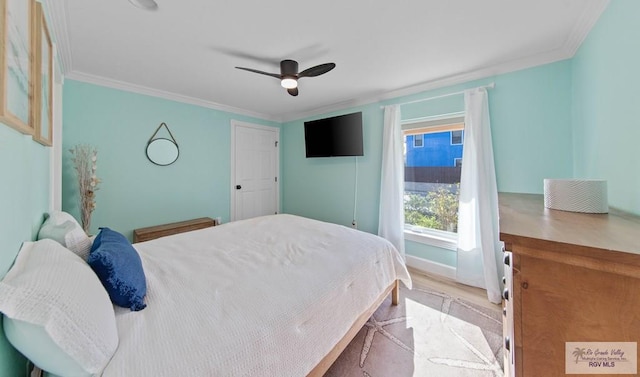 bedroom featuring crown molding, wood finished floors, a ceiling fan, and baseboards