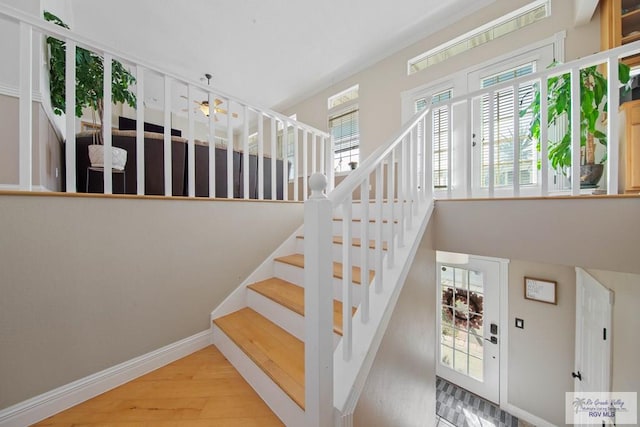 staircase with wood finished floors and baseboards