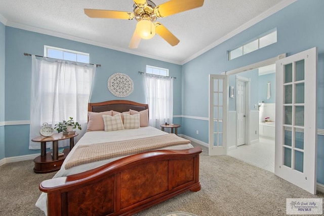 carpeted bedroom with a textured ceiling, french doors, baseboards, and ornamental molding