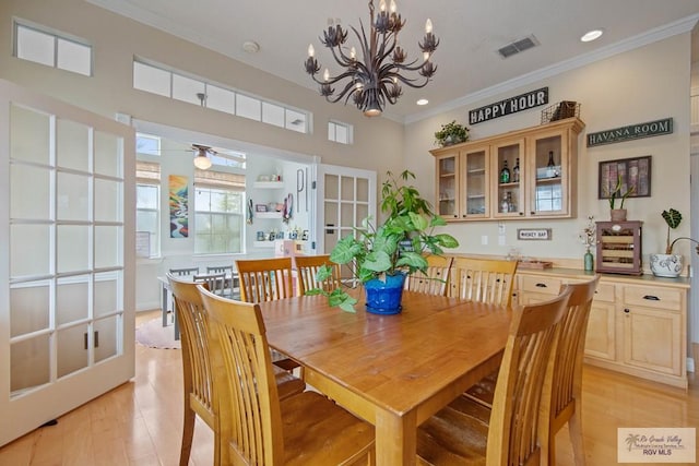 dining room featuring visible vents, crown molding, a chandelier, recessed lighting, and light wood-style floors