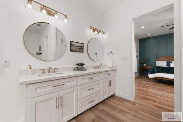 1709 Thacker Ln, Harlingen, TX 78552 - ensuite bathroom with baseboards, wood finished floors, a sink, and ensuite bathroom