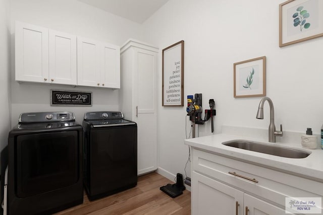 1709 Thacker Ln, Harlingen, TX 78552 - washroom with independent washer and dryer, wood finished floors, a sink, and cabinet space