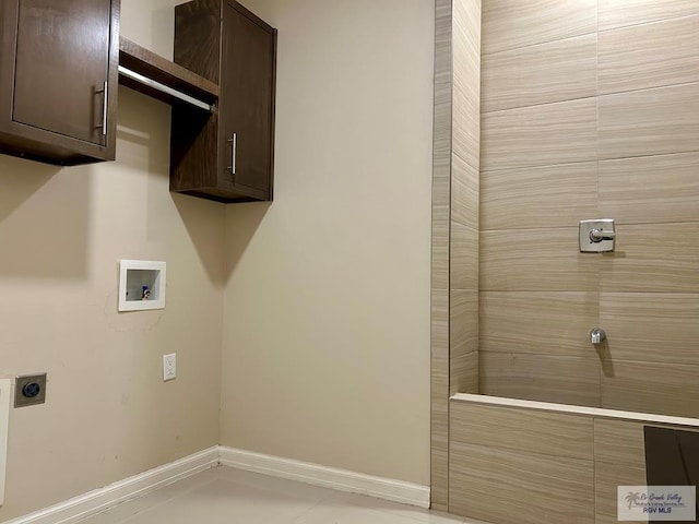 laundry area with cabinets, hookup for an electric dryer, and hookup for a washing machine