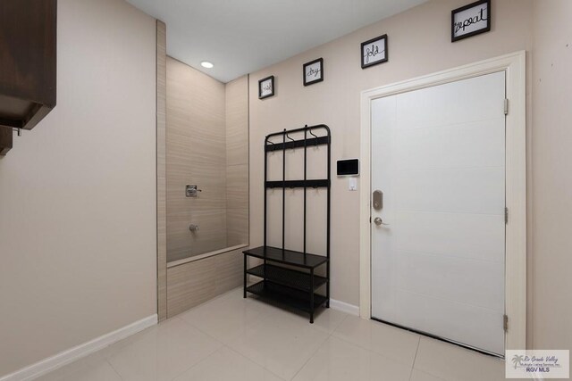 doorway to outside featuring light tile patterned flooring