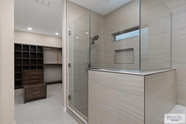 bathroom with walk in shower and tile patterned floors