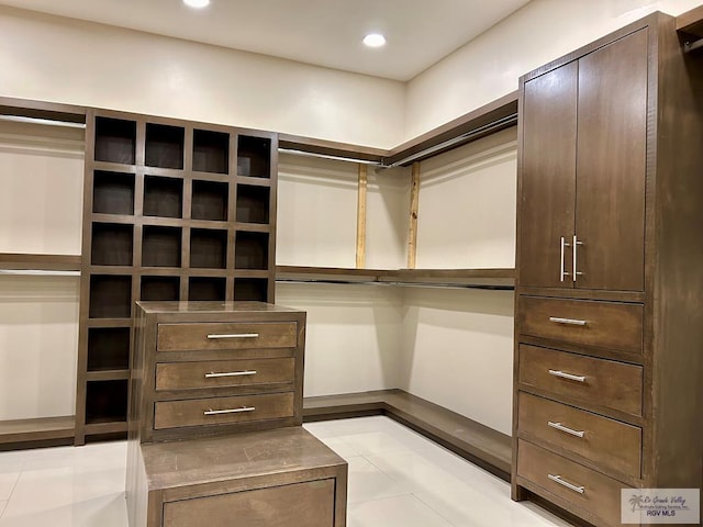 walk in closet featuring light tile patterned flooring