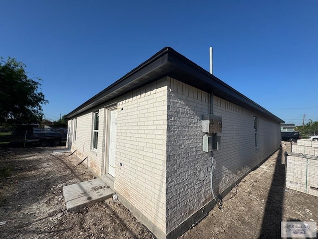 view of side of property with brick siding