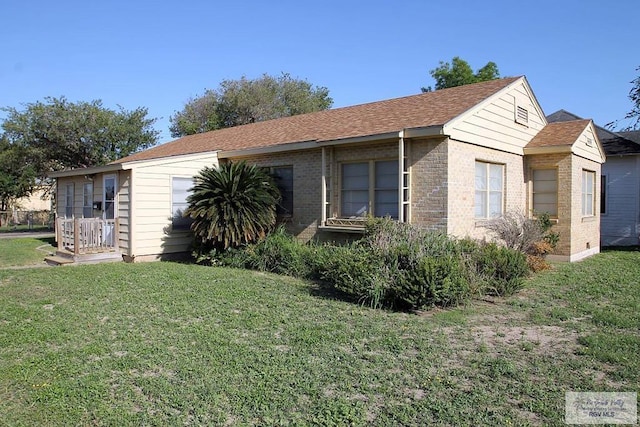 view of property exterior featuring brick siding and a yard