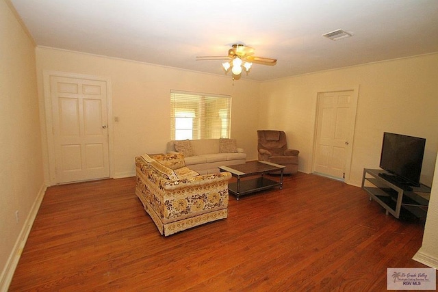 living room with wood finished floors, a ceiling fan, and baseboards