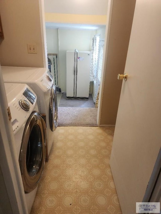 laundry area featuring washing machine and clothes dryer