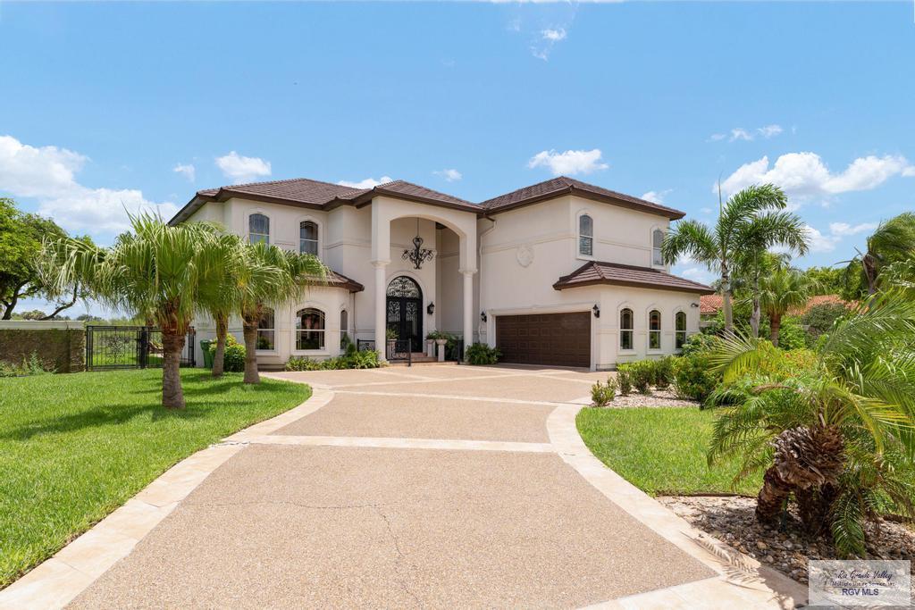 mediterranean / spanish-style home featuring a garage and a front yard