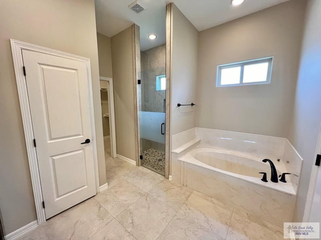814 Knotty Pine Ln, Harlingen, TX 78552 - full bathroom featuring marble look tiles, a stall shower, a bath, a walk in closet, and recessed lighting