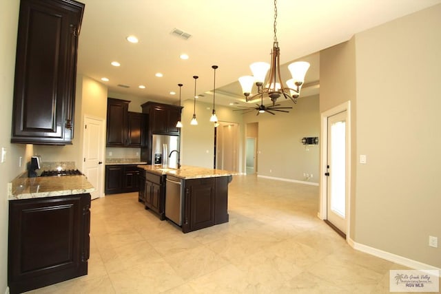 814 Knotty Pine Ln, Harlingen, TX 78552 - kitchen with a chandelier, appliances with stainless steel finishes, dark brown cabinetry, decorative light fixtures, and recessed lighting