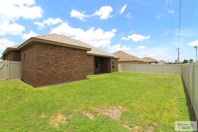 814 Knotty Pine Ln, Harlingen, TX 78552 - rear view of property with brick siding, a fenced backyard, and roof with shingles