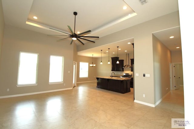 814 Knotty Pine Ln, Harlingen, TX 78552 - unfurnished living room featuring a ceiling fan, recessed lighting, and a tray ceiling