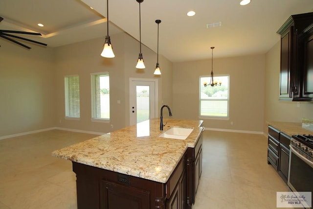 814 Knotty Pine Ln, Harlingen, TX 78552 - kitchen featuring stainless steel gas range oven, recessed lighting, a chandelier, open floor plan, and dark brown cabinets