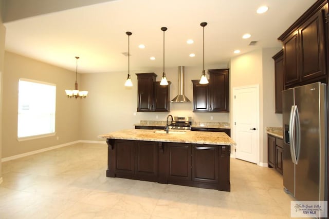 814 Knotty Pine Ln, Harlingen, TX 78552 - kitchen with appliances with stainless steel finishes, wall chimney range hood, dark brown cabinetry, a chandelier, and recessed lighting