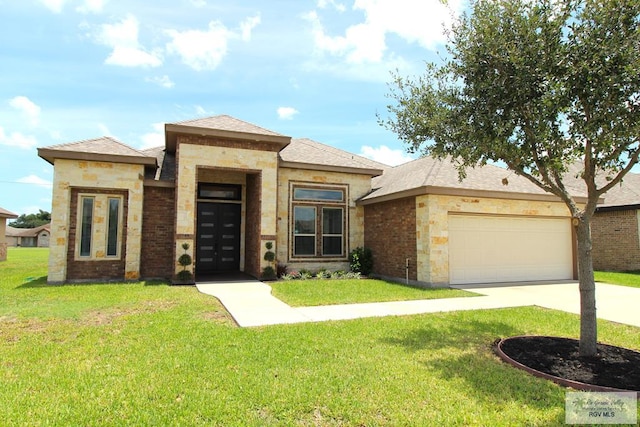 814 Knotty Pine Ln, Harlingen, TX 78552 - prairie-style house featuring a front lawn, a garage, a shingled roof, and stone siding