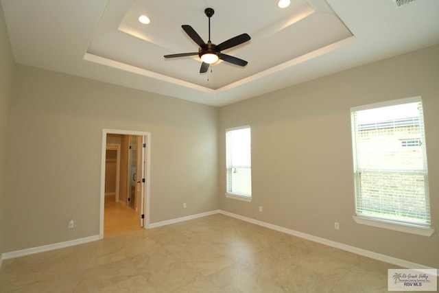 814 Knotty Pine Ln, Harlingen, TX 78552 - unfurnished room featuring healthy amount of natural light, a tray ceiling, a ceiling fan, recessed lighting, and light marble finish floors