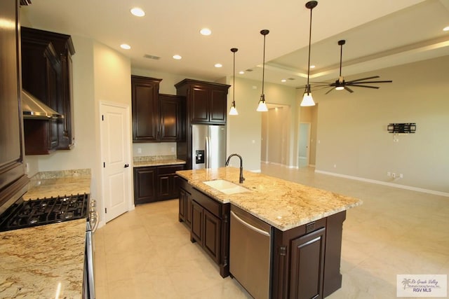 814 Knotty Pine Ln, Harlingen, TX 78552 - kitchen featuring stainless steel appliances, recessed lighting, a kitchen island with sink, hanging light fixtures, and dark brown cabinets