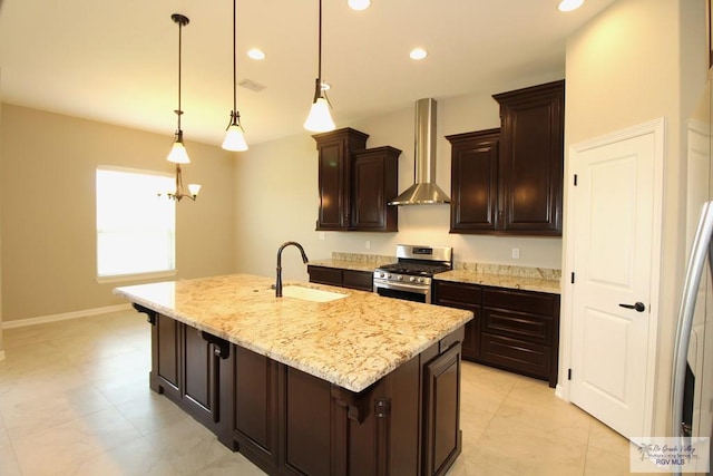 814 Knotty Pine Ln, Harlingen, TX 78552 - kitchen with stainless steel gas range, wall chimney range hood, light stone countertops, recessed lighting, and an island with sink