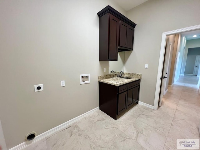 814 Knotty Pine Ln, Harlingen, TX 78552 - laundry room featuring washer hookup, hookup for an electric dryer, light marble finish flooring, and cabinet space