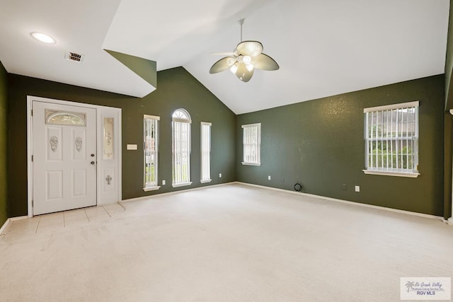 carpeted empty room with ceiling fan and lofted ceiling