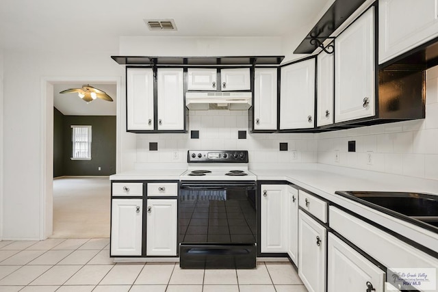 kitchen featuring white cabinetry, sink, backsplash, white range with electric cooktop, and light carpet