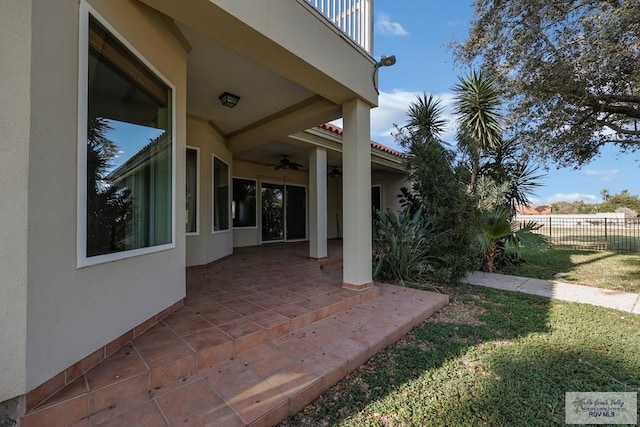 view of patio / terrace featuring a ceiling fan and fence