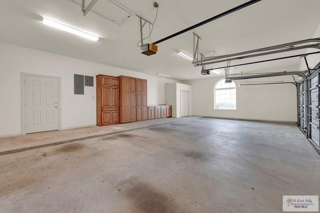 garage with electric panel, a garage door opener, and baseboards