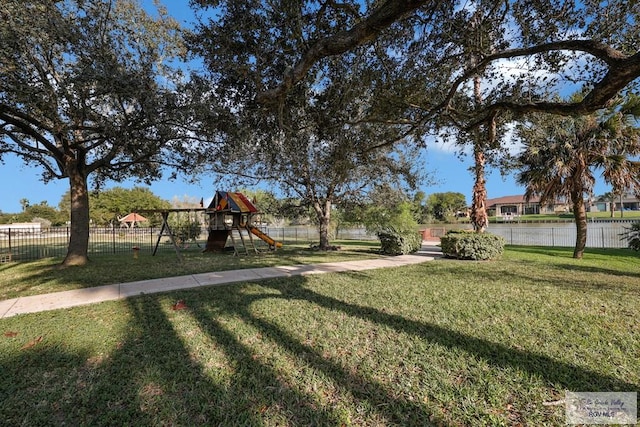 view of yard with playground community and fence