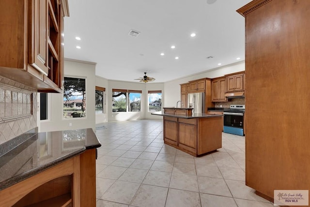 kitchen with visible vents, light tile patterned flooring, stainless steel fridge with ice dispenser, range with electric cooktop, and under cabinet range hood