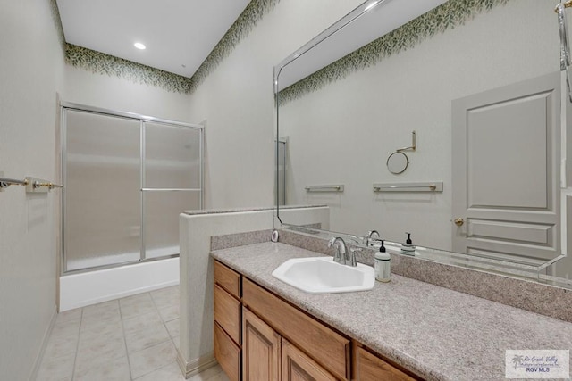 bathroom with vanity, tile patterned floors, and combined bath / shower with glass door