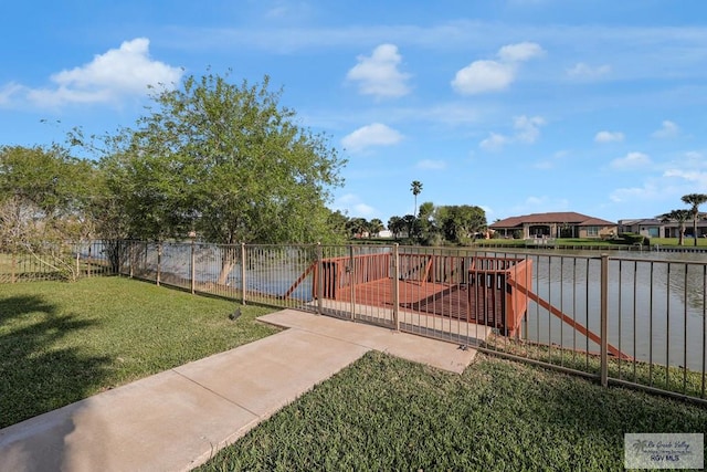 view of yard with fence and a water view