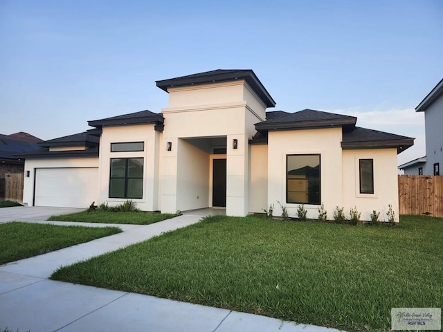 1321 White Oak Dr, Harlingen, TX 78522 - prairie-style home with a garage, stucco siding, and driveway