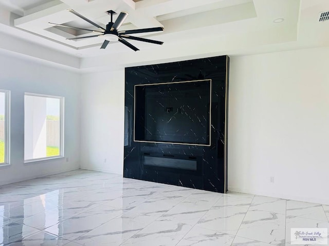 1321 White Oak Dr, Harlingen, TX 78522 - empty room featuring ceiling fan, coffered ceiling, baseboards, a raised ceiling, and marble finish flooring