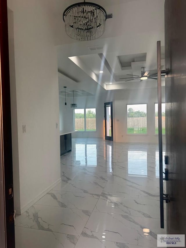 1321 White Oak Dr, Harlingen, TX 78522 - hall with baseboards, marble tiled floors, and a raised ceiling