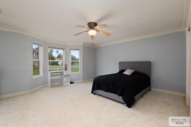 carpeted bedroom featuring ceiling fan and crown molding