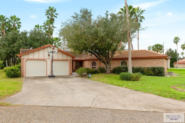 view of front of house with a front yard and a garage