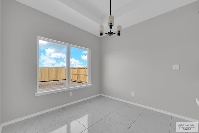 empty room featuring a notable chandelier