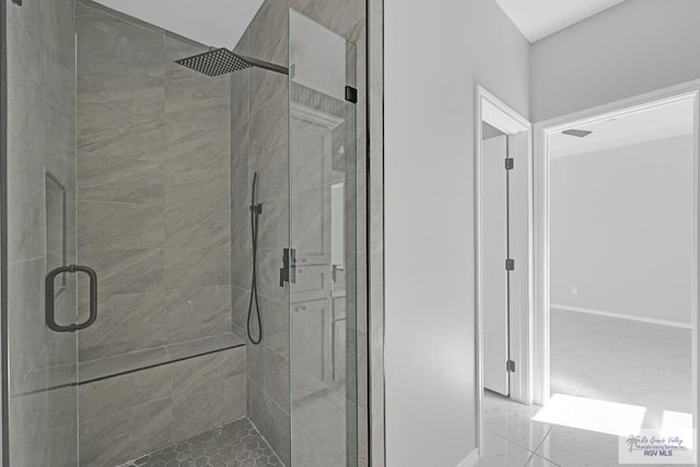 bathroom with a shower with door