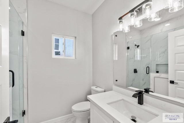 bathroom with vanity, an enclosed shower, and toilet