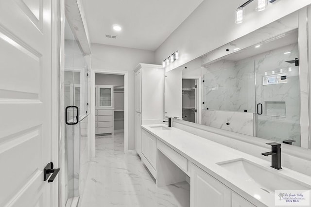 bathroom with vanity and a shower with shower door