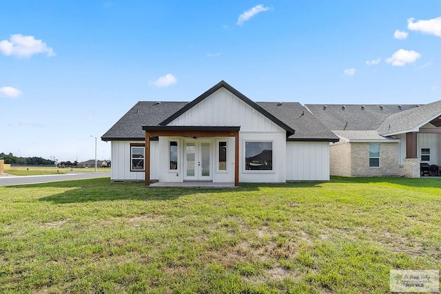 view of front of house featuring french doors and a front lawn