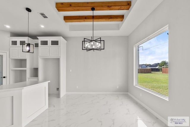 unfurnished dining area featuring plenty of natural light, beam ceiling, and an inviting chandelier